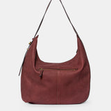 Burgundy suede shoulder bag.
