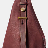 Burgundy suede shoulder bag.