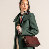 Burgundy suede crossbody bag.