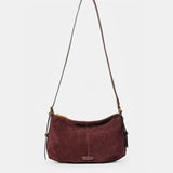 Burgundy suede shoulder bag.
