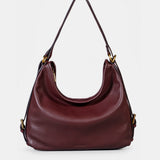 Multifunctional burgundy leather bag.