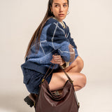 Multifunctional burgundy leather bag.