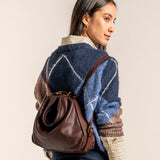 Multifunctional burgundy leather bag.