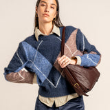 Multifunctional burgundy leather bag.