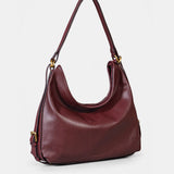 Multifunctional burgundy leather bag.