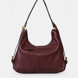 Multifunctional burgundy leather bag.