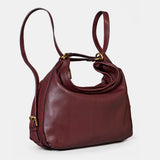 Multifunctional burgundy leather bag.