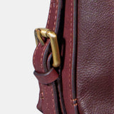 Multifunctional burgundy leather bag.