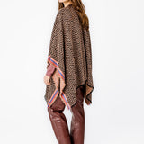 Poncho with geometric print in pink tones