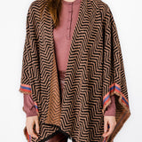 Poncho with geometric print in pink tones