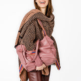 Poncho with geometric print in pink tones