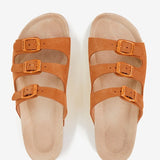 Women's flat leather sandal with triple buckle in cognac