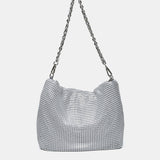 Schultertasche aus weißem Metallnetz.
