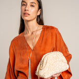Sequin clutch bag in beige.