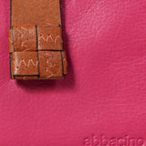 Piccola borsa da donna in pelle fucsia.