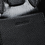 Bolso de mano de charol en negro