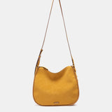 Shoulder bag made from recycled materials in amber.