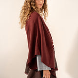Burgundy poncho with a bow.
