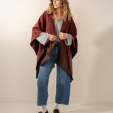 Burgundy poncho with a bow.
