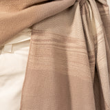 Beige plaid adjustable poncho.