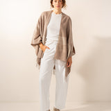 Beige plaid adjustable poncho.