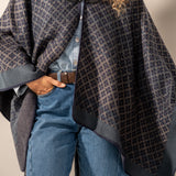Poncho with blue geometric print.