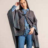 Poncho with blue geometric print.